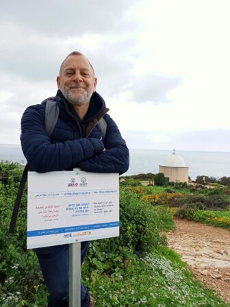 Rabbi Amichai on the Top of Mount Carmel in Haifa, Israel, on the launch of Below the Bible Belt, February 6 2022. The sign reads: