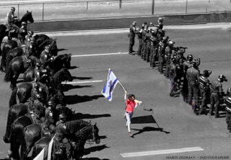 Protestor holding Israeli flag