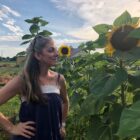 Naomi Less admiring sunflower